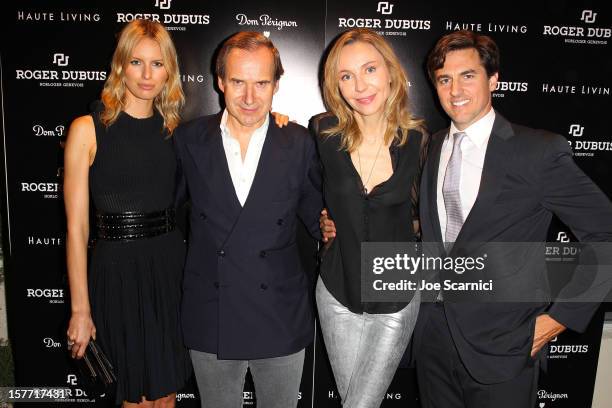 Model Karolina Kurkova and Archie Drury pose with guests at the Haute Living and Roger Dubuis dinner hosted by Daphne Guinness at Azur on December 5,...