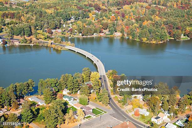 curved bridge over lake autumn aerial - chetek, wisconsin - small town community stock pictures, royalty-free photos & images