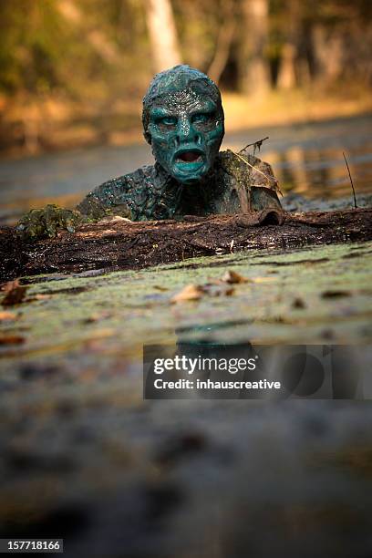 swamp monster lurking in the water - swamp monster stock pictures, royalty-free photos & images