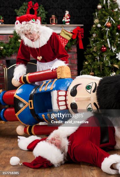 mrs. claus discovers santa injured - fat man lying down stock pictures, royalty-free photos & images