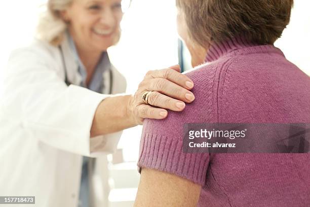 doctor comforting a patient at the hospital - examination closeup stock pictures, royalty-free photos & images