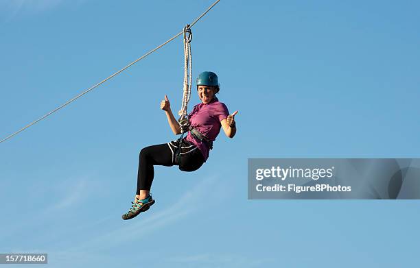 ziping mädchen auf canopy tour - zip line stock-fotos und bilder