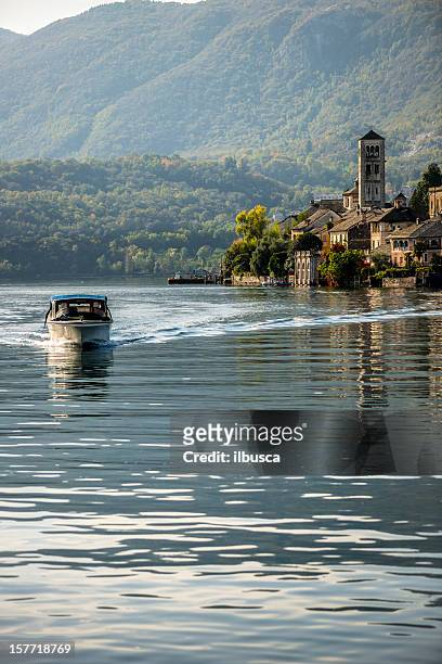 orta san giulio island with boat - lake orta stock pictures, royalty-free photos & images