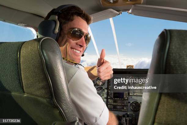 corporate jet pilot giving thumbs up - piloot stockfoto's en -beelden
