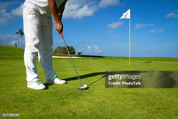 male golfer putting on golf green - golf course hole stock pictures, royalty-free photos & images