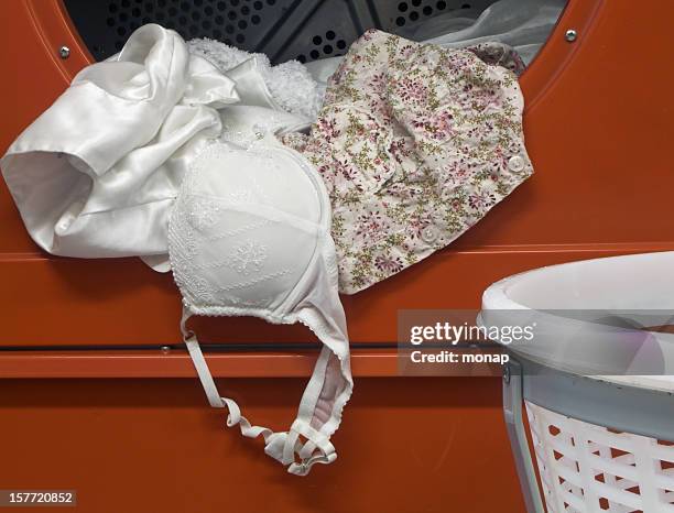 laundry in a tumbler dryer - bra stock pictures, royalty-free photos & images