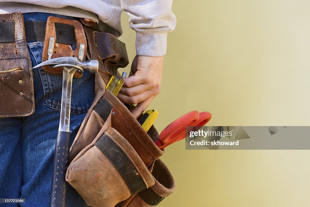 Young Construction Worker Reaches Into His Tool Belt Copy Space