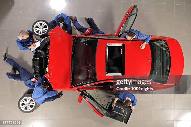 auto mechanic team repairing the sports car - plant from above stock pictures, royalty-free photos & images