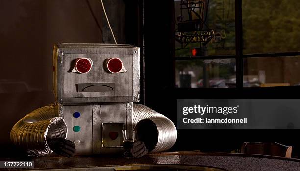 traurig roboter in der bar - robot costume stock-fotos und bilder