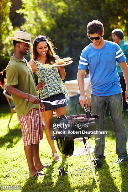 friends having a bbq. - los angeles garden party stock pictures, royalty-free photos & images