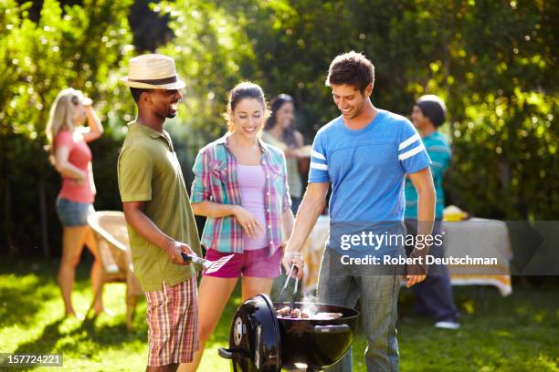 friends having a bbq. - los angeles garden party stock pictures, royalty-free photos & images