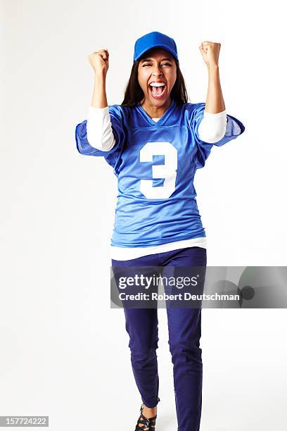 woman cheering in sports jersey. - woman in sports jersey stock pictures, royalty-free photos & images