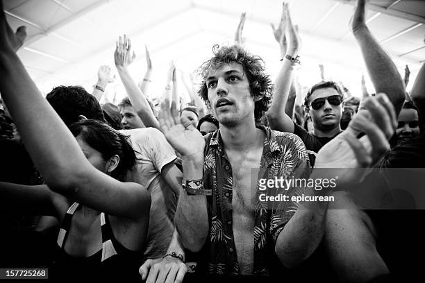 young man clapping as he watches a performance - concert face stock pictures, royalty-free photos & images