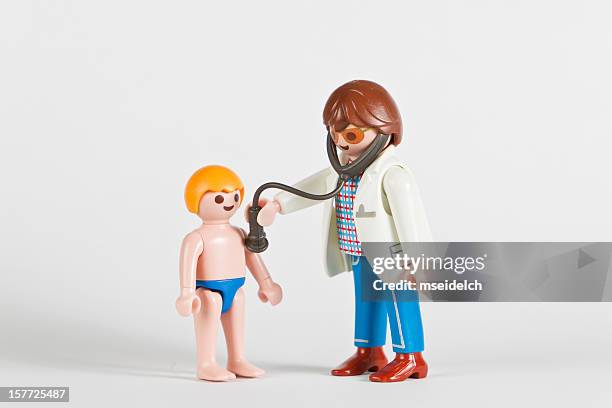 playmobil doctor phd examining a boy - playmobil stock pictures, royalty-free photos & images