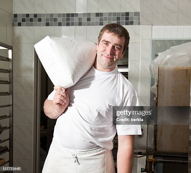 baker with sack of flour - flour bag stockfoto's en -beelden