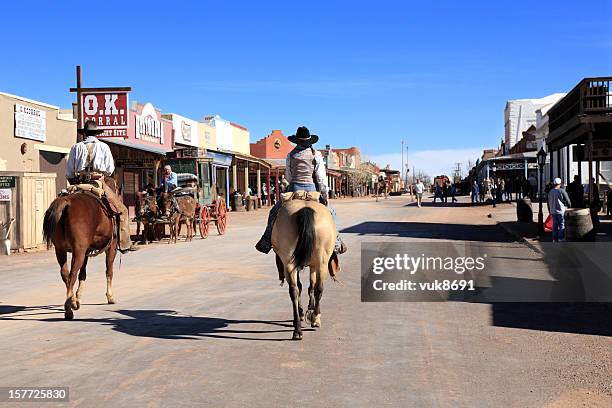 cowboys ride into tombstone - old west town stock pictures, royalty-free photos & images