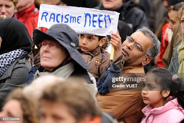 boy holding a banner in an anti-racism protest - anti racism children stock pictures, royalty-free photos & images