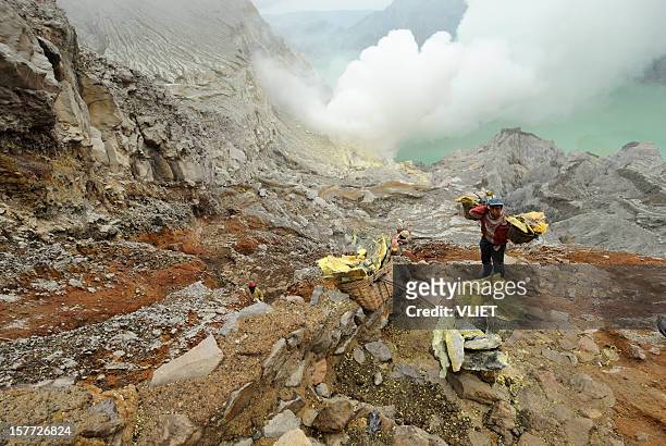 sulphur mining at kawa ijen in indonesia - sulfuric acid stock pictures, royalty-free photos & images