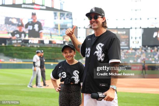 Musician Jake Owen and his daughter, Pearl, look on prior to the game between the Chicago White Sox and the Cleveland Guardians at Guaranteed Rate...