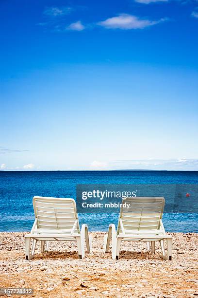 sun beds at lonely beach - croatia coast stockfoto's en -beelden