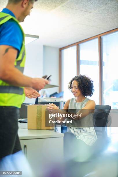 courier picks up parcel at office - lift stock pictures, royalty-free photos & images