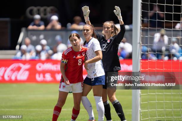 Angharad James of Wales, Alex Morgan of the United States, Olivia Clark of Wales battle for goal during an international friendly game between Wales...