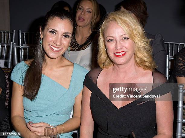 Actresses Annika Marks and Virginia Madsen attend fashion designer Kevan Hall's Spring 2013 Collection on December 5, 2012 in Los Angeles, California.
