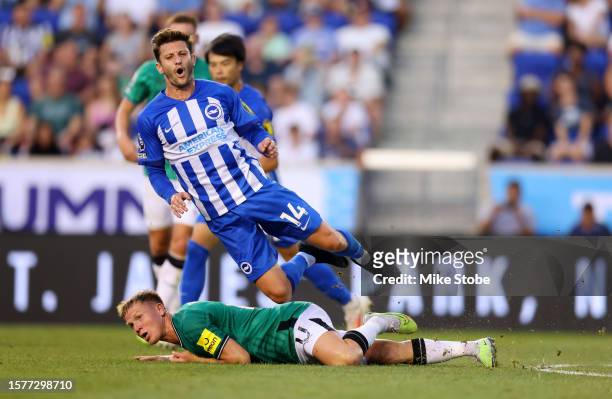 Matt Ritchie of Newcastle United and Adam Lallana of Brighton & Hove Albion collide during the Premier League Summer Series match between Brighton &...