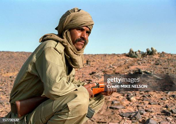 Polisario fighter on guard near the front line with Morocco, 15 June 1988, in Polisario-controlled Western Sahara. The Polisario front, an armed...