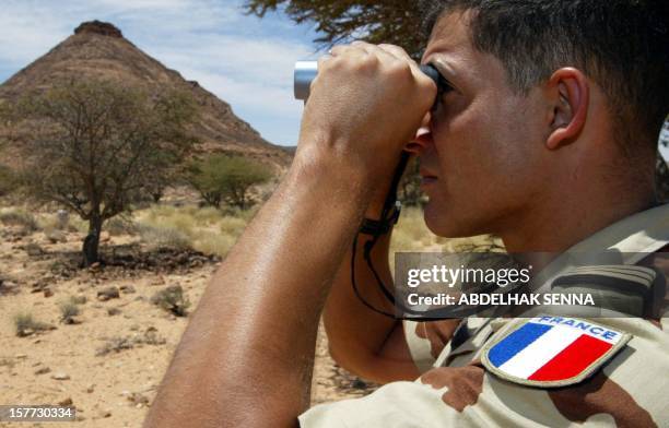 French soldier of the United Nations mission for the organization of a referendum in Western Sahara watches moves of Moroccan troops at the Oum...