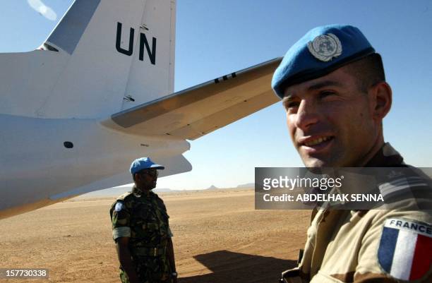French soldier of the United Nations mission for the organization of a referendum in Western Sahara stands next to a UN plane on the landing track at...