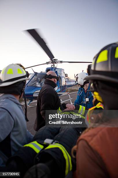 transporting a patient to waiting helicopter - air ambulance stock pictures, royalty-free photos & images