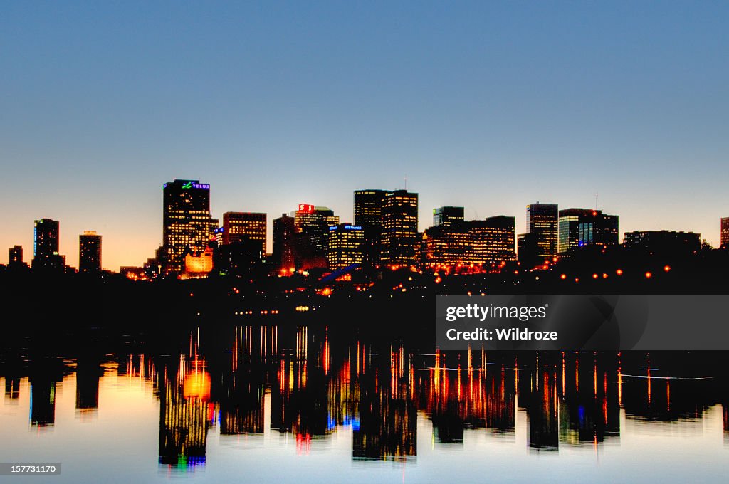 Edmonton skyline at sunset reflected in river