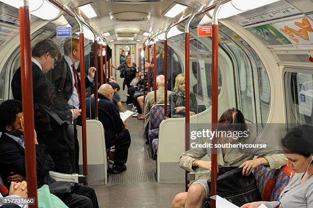 people in london underground - redactioneel stockfoto's en -beelden