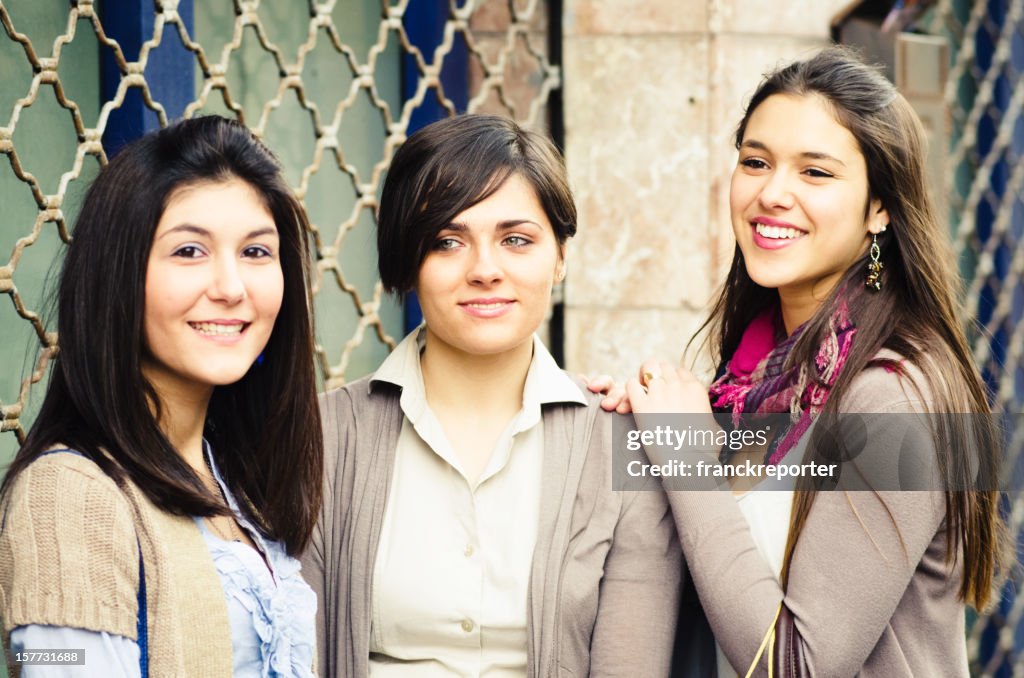 Cheerful friends laughing outdoors the store