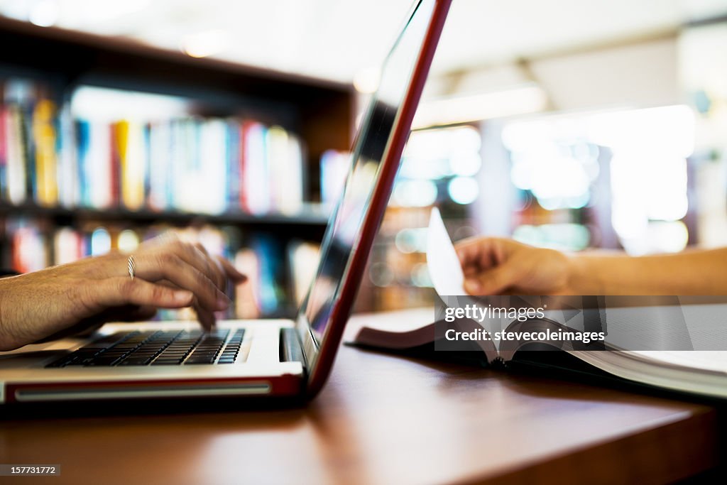 Laptop Computer and Book on Table
