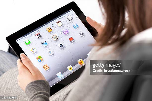 holding ipad 2 - homescreen stock pictures, royalty-free photos & images