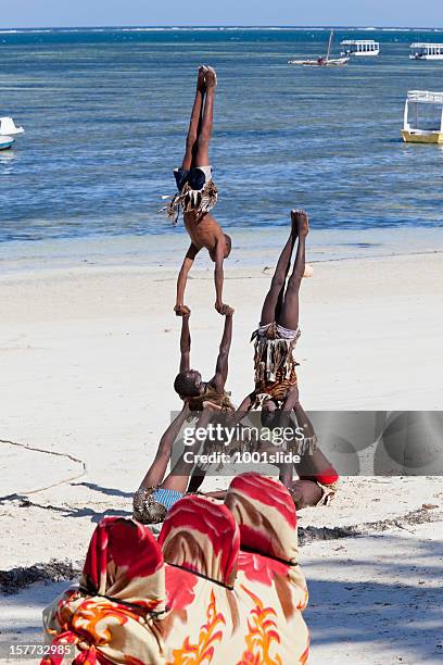 young acrobats at bamburi beach - mombasa stock pictures, royalty-free photos & images