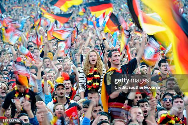 soccer fans at public viewing area brandenburger tor - football scarf stock pictures, royalty-free photos & images