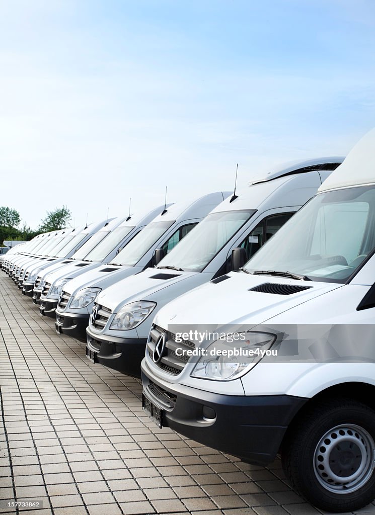 White Mercedes-Benz transporters in a row