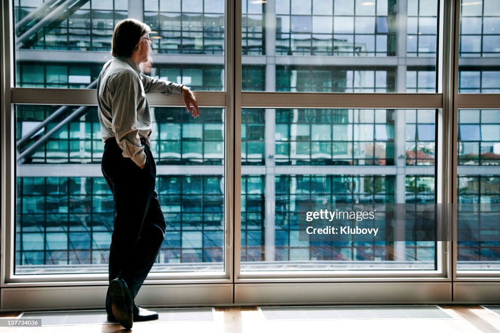 Businessman looking through window