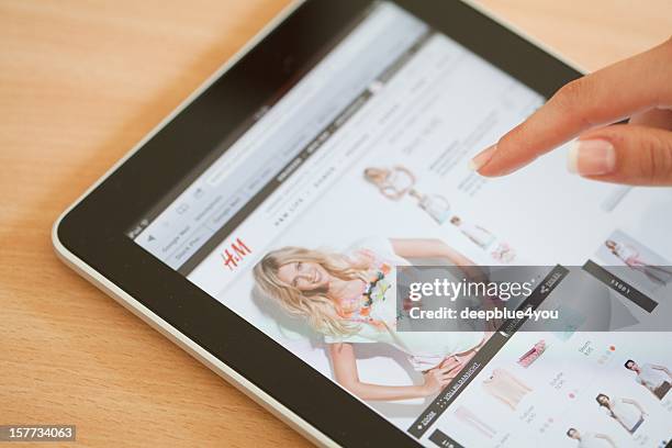 online shopping with ipad at h&m store - h m store stock pictures, royalty-free photos & images