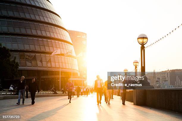 people walking on the riverside - gla building stock pictures, royalty-free photos & images