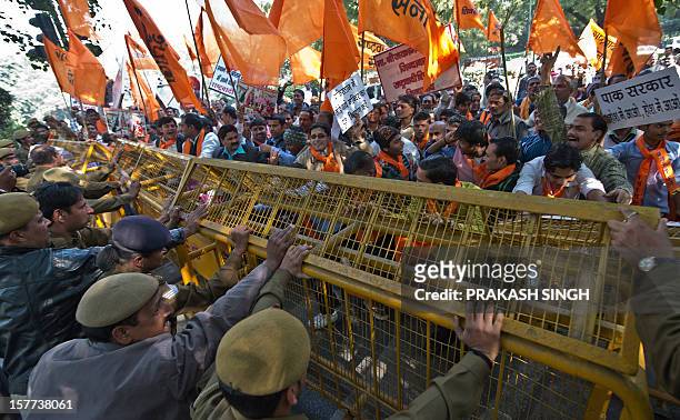 Activists of right wing Hindu Rashtrawadi Sena activists push a police barricade as they shout slogans demanding the construction of the Ram Temple...