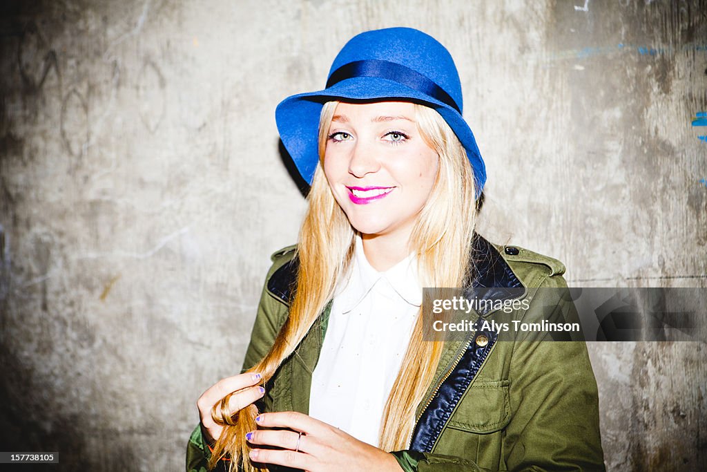 Portrait of a smiling young woman in a blue hat