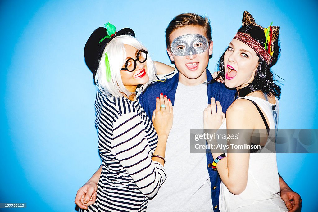 Portrait of three young people celebrating