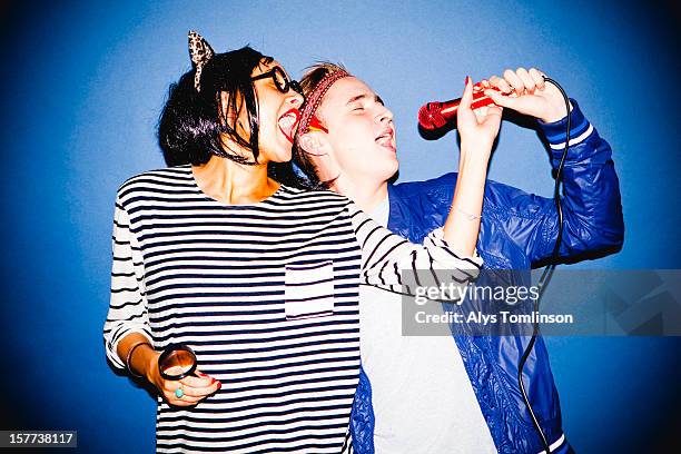 portrait of two young people in fancy dress - karaokê - fotografias e filmes do acervo