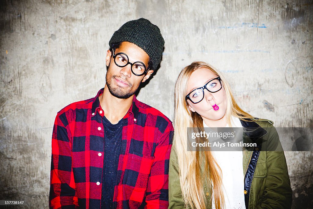 Portrait of two young people pulling funny faces