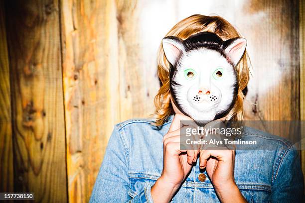 portrait of a woman wearing a mask - mask disguise stock-fotos und bilder