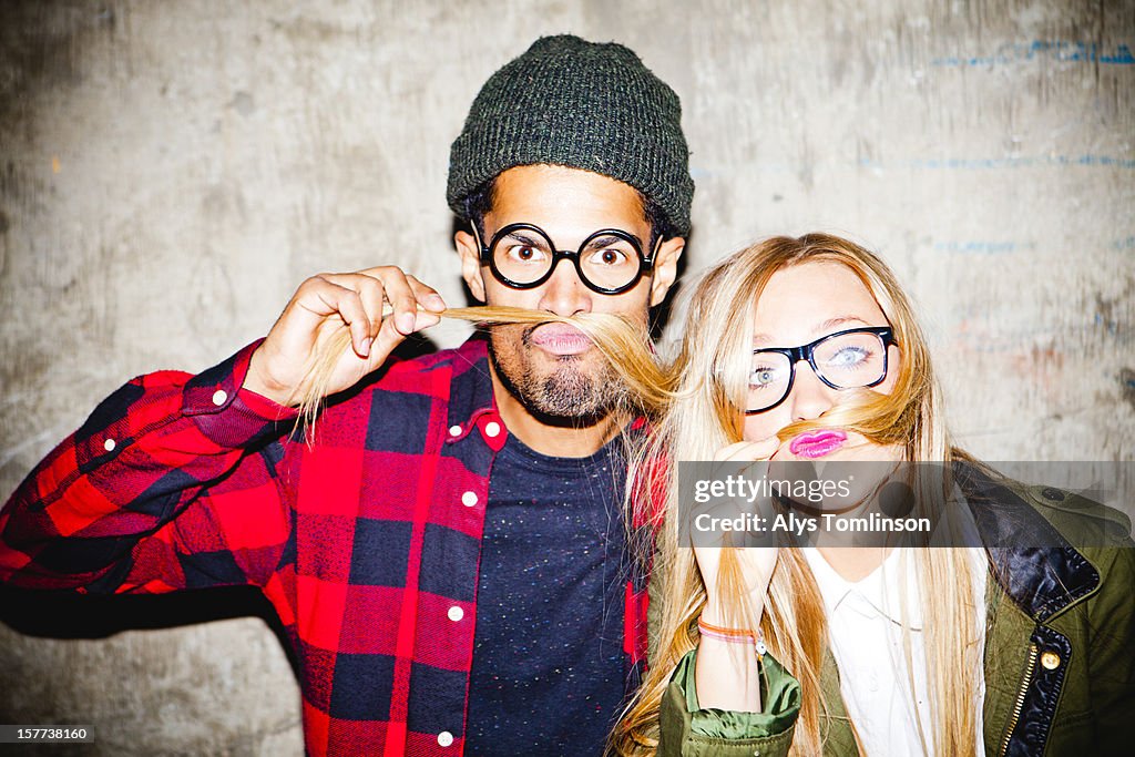 Portrait of two young people pulling funny faces